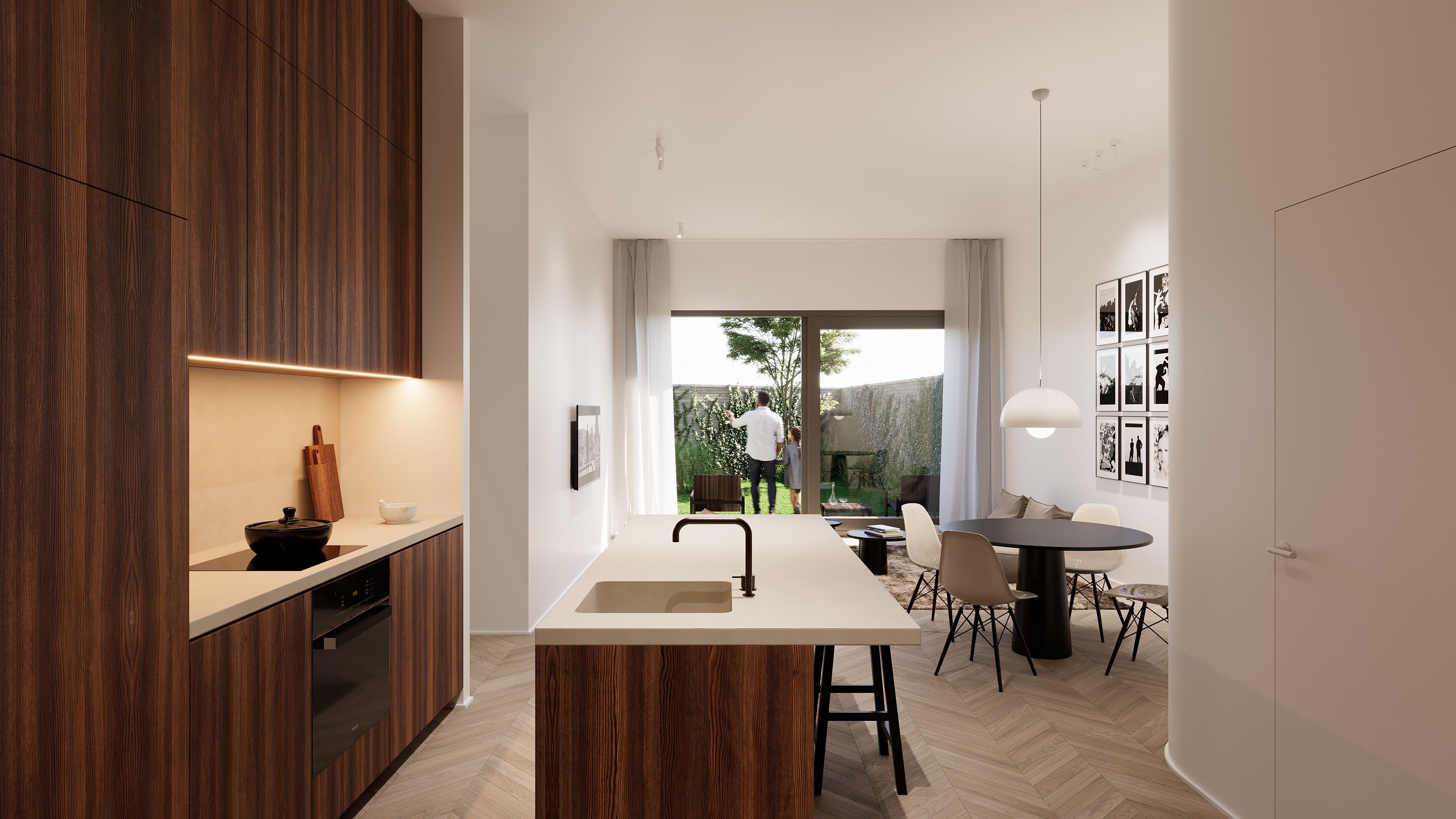 Cuisine dans un projet neuf avec un ilot central. On aperçoit une table, des chaises et une baie vitrée en second plan