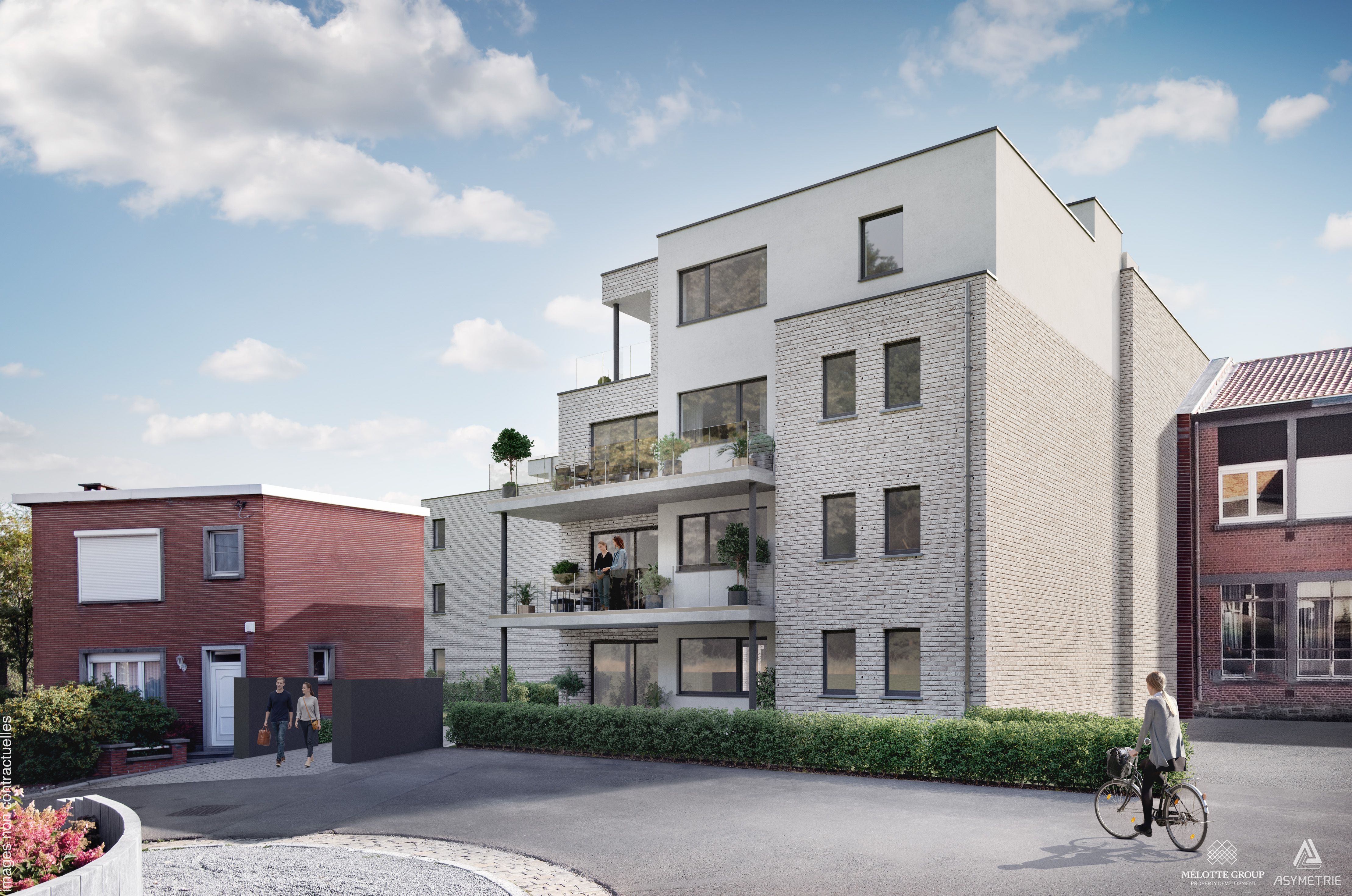 Immeuble résidentiel contemporain avec façades en briques claires et terrasses superposées. Le bâtiment s’intègre dans un quartier résidentiel, entre habitations existantes et espaces extérieurs aménagés.