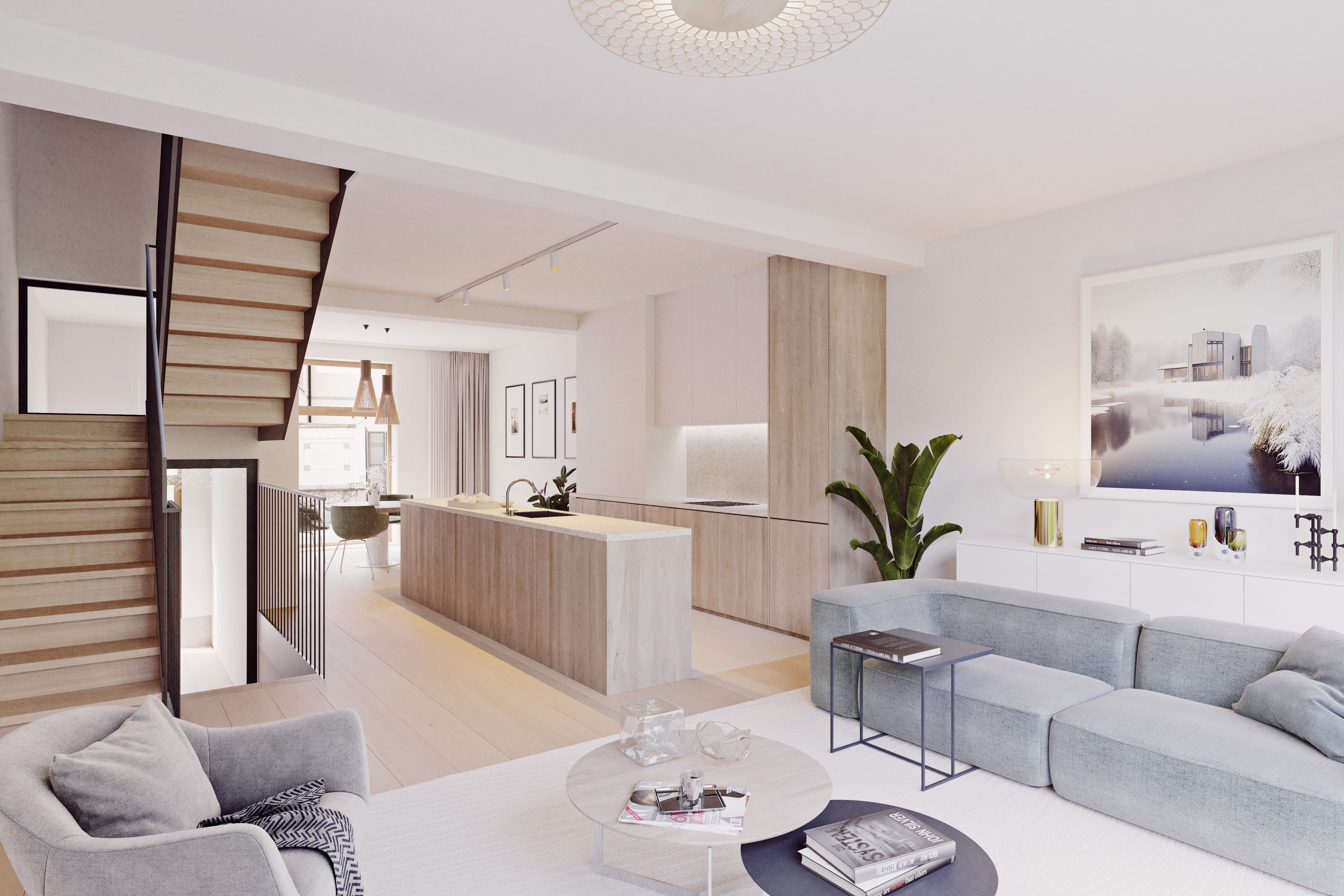 Large espace de vie dans une maison à Bruxelles. Un salon est présenté en premier plan, suivi d'une cuisine et d'un escalier à gauche de l'image