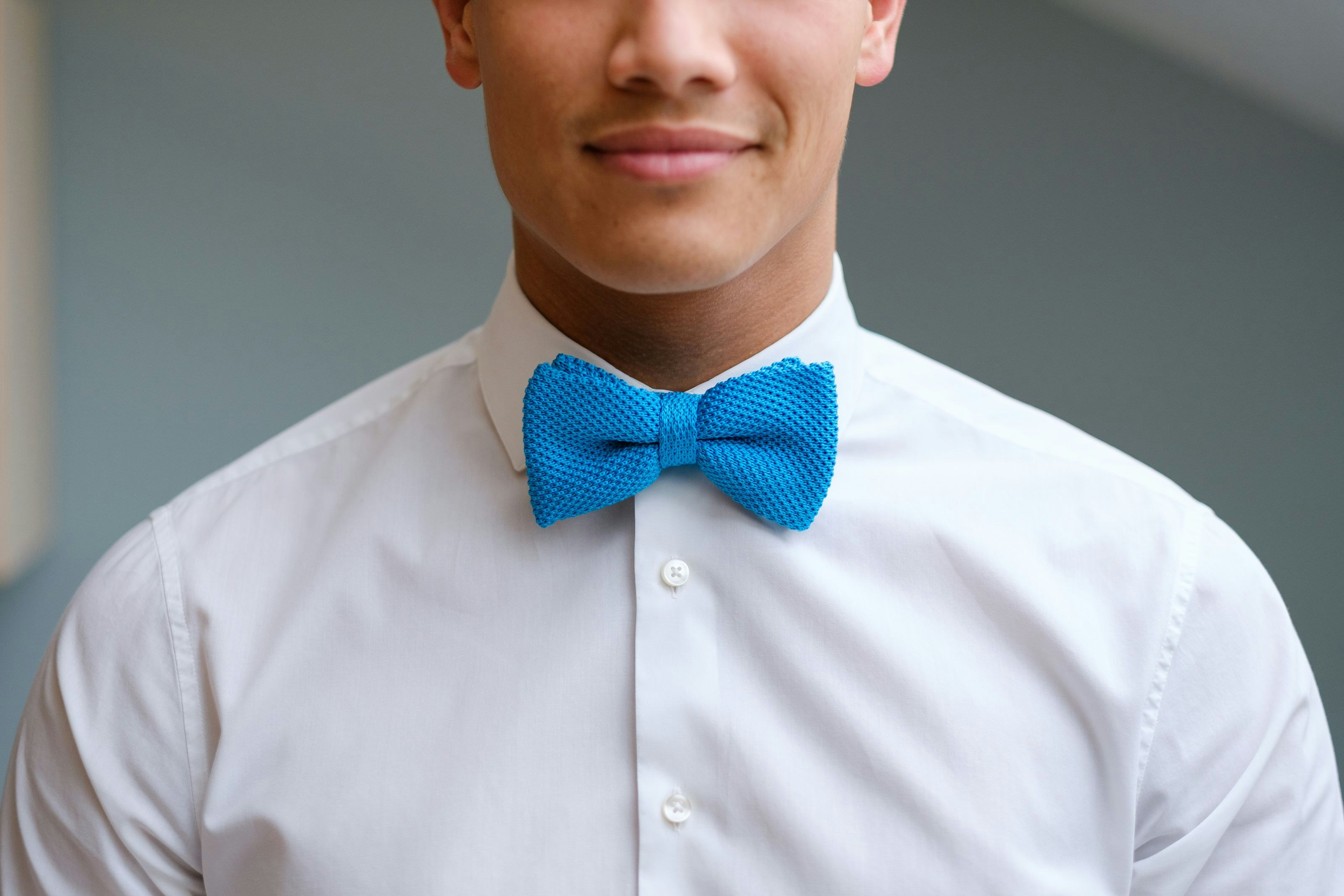 Jonathan Pham's face with a blue bow tie, founder of We Invest Real Estate