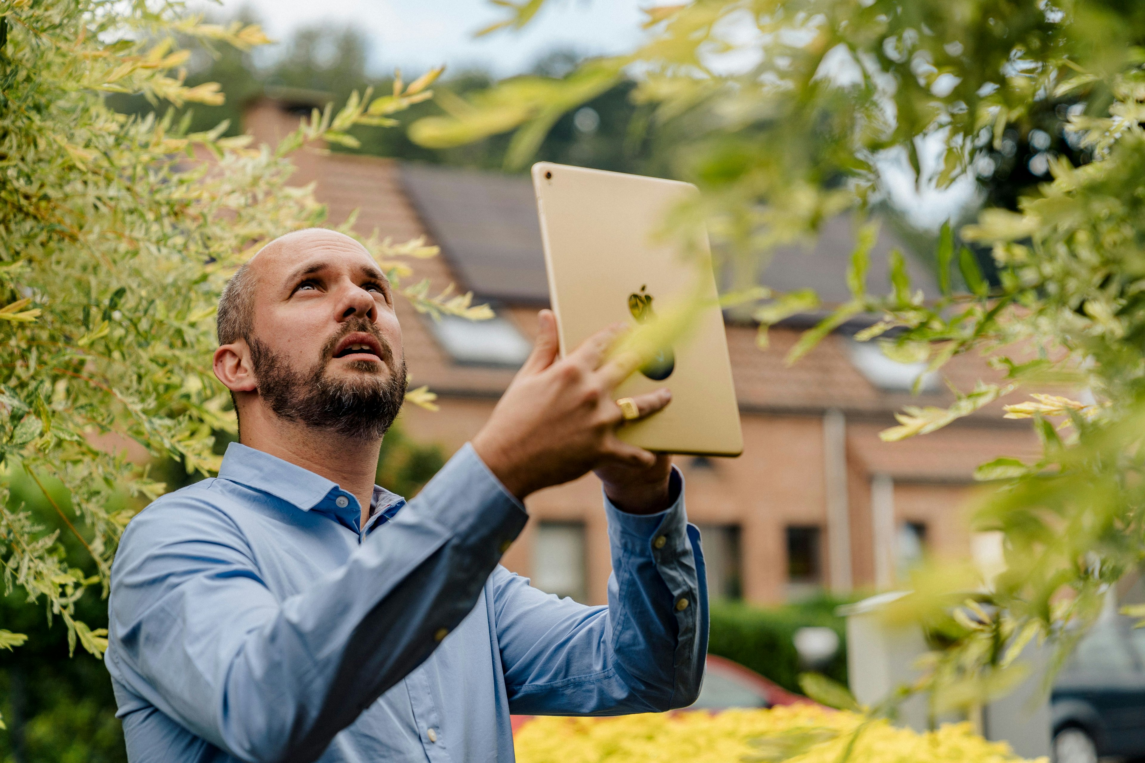 We Invest real estate agent value a house on his tablet and completes a detailed valuation report.